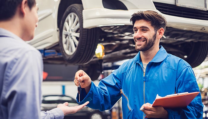 service technician handing customer key